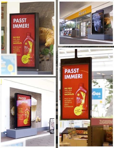 City Light Poster mit Werbung für Nachfüllöl an Tankstelle